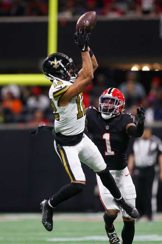 New Orleans Saints receiver Chris Olave (12) catches a pass over Atlanta Falcons cornerback Jeff Okudah (1). Mandatory Credit: Brett Davis-USA TODAY 